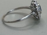 a silver ring with a blue stone in it