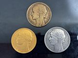 three different coins sitting on top of a table next to each other