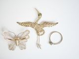 two rings and a ring holder with a bird on it