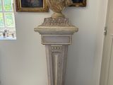 a statue of a man on a pedestal in a room