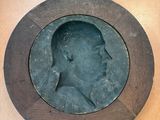 a picture of a man ' s head in a wooden frame