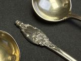 two spoons that are sitting on a table