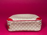 a white and red purse sitting on top of a pink surface