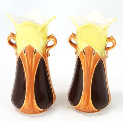 two vases that are sitting on a white surface