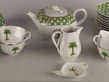 a lot of cups and saucers sitting on a table