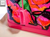 a pink purse with a rose design on it
