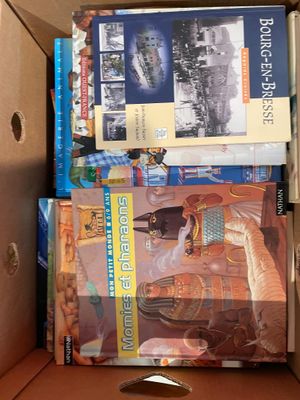 a box full of books and a pair of scissors in it
