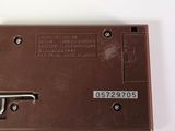 a picture of a brown electronic device on a white surface