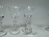 four wine glasses sitting next to each other on a table