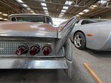 two cars that are parked inside of a building