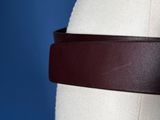 a close up of a mannequin torso with a brown leather belt