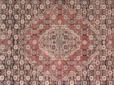 an antique persian rug with a medallion design on the center