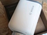a white cell phone sitting in a box on the floor