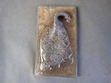 a metal object with a bird on it sitting on a table