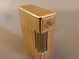 a gold lighter that is sitting on a table