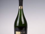 a bottle of champagne sitting on top of a white table