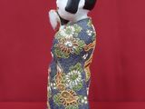 a small figurine of a woman in a kimono