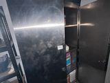 an image of a refrigerator in a room with a ladder