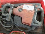 a red box with a tool in it that is sitting on a table