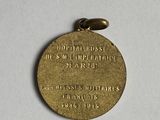 a close up of a medal on a white surface with a white background