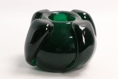 a green vase that is sitting on a white surface
