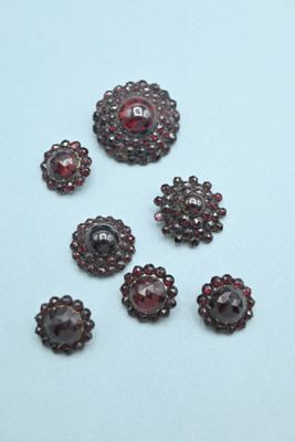 several pieces of garnets are arranged on a white surface