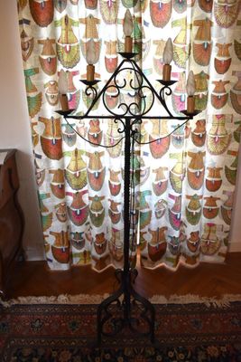 an image of a candle stand in front of a curtain