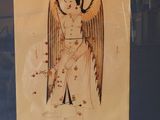 painting of an angel in a glass case on display in a museum
