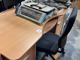 a desk with a typewriter and a chair in a room