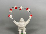 toy figurine of a man holding a kite in the air
