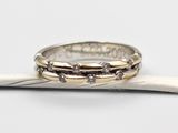 a close up of two rings on a stick with a white background