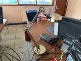 a desk with a computer and a lamp on it