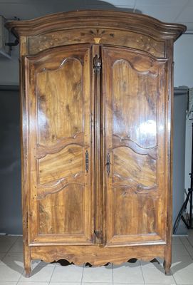 a large wooden armoire in the middle of a room