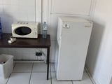 une petite table sur laquelle se trouve un micro-ondes, dans la cuisine