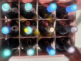 many bottles of wine in a wine rack on the table