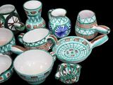 many different types of pottery on display on a black background