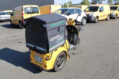 a motorcycle with a box on the back parked in a parking lot