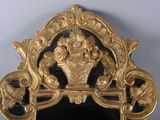 a mirror with a gold frame and a black background