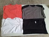 three t - shirts are sitting on a table in a row