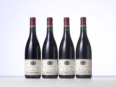 three bottles of wine are lined up on a table