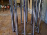 a glass table with a metal base on a wooden floor
