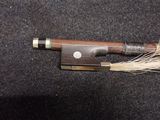 a bow and a knife laying on a black surface
