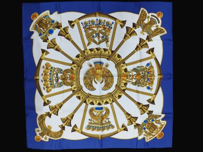 a close up of a blue and white square with gold decorations