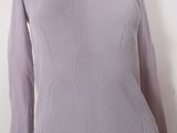the back of a woman ' s sweater with a long sleeve and a turtle neck
