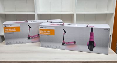 two pink scooters that are sitting on a table
