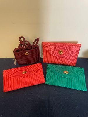 three small purses sitting on top of a table next to each other