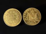 two gold coins, one of which has a crown and the other of which has a crown on it