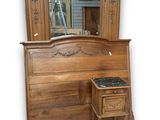 a wooden dresser with a mirror on top of it
