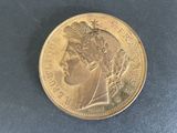 an image of a gold coin with a woman ' s head on it