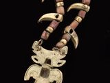 a close up of a necklace on a black background